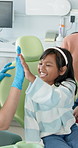 Child, dentist and high five with smile, checkup and education for oral hygiene and appointment. Girl, healthcare and dental care with tooth decay prevention and orthodontist visit in medical clinic