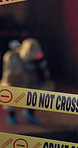 Crime scene, barricade and no entry with sign for murder investigation or protection of evidence at night. Closeup of road closure for emergency, justice or forensic team taking pictures of mystery