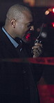 Investigator, talking and man on crime scene, police tape and officer with radio communication for backup. Investigation, accident and dispatch for criminal, professional and listening for protocol