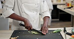 Person, hands and chef with knife or vegetables as cooking in industrial kitchen, cuisine or professional. Chopping, board and hospitality or customer service in restaurant or food, prepare or dinner