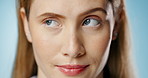 Woman, face and annoyed with rolling eyes in studio with closeup, bored and drama for choice by blue background. Girl, person and model with attitude, moody and frustrated in portrait with decision