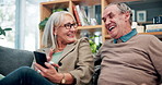 Laugh, phone and senior couple on sofa with connection, subscription or online funny website in home. Scroll, old woman and happy man on couch with smartphone, retirement or mobile app in living room
