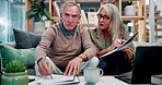 Paperwork, debt and senior couple on sofa with home budget, pension plan or insurance application. Laptop, man and woman on couch with retirement documents, writing notes or discussion in living room