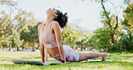 Yoga, stretching and woman in park with cobra pose for holistic wellness, muscle and flexible body. Young person or yogi practice in garden, nature or outdoor with peace, zen and calm for balance