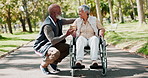 Park, old man and senior woman in wheelchair, nature and conversation with support, love and marriage. Outdoor, couple and person with disability, summer and relationship with trees, care and talking