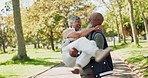 Happy, interracial and senior couple with love in park for romance, support or care in nature. Man carrying woman with smile for romantic date or playing in forest, woods or outdoor celebration