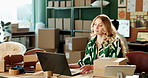 Woman, typing and laptop in warehouse for order with invoice, verify shipping information or distribution. Logistics, employee and supplier with inventory check, supply chain and package pricing