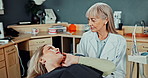 Woman, mouth and conversation in appointment with dentist for explain symptoms or treatment options and check up. Mature, doctor and girl consulting for oral health education and teeth advice.