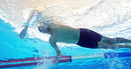 Swimmer, man and training in pool with low angle for speed, cardio and workout for global competition. Person, athlete and underwater for fast stroke, sports and exercise for international contest