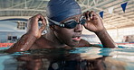 African man, athlete and goggles in swimming pool for speed, cardio or ready for global competition. Person, athlete and thinking with vision for exercise, sport or prepare for international contest