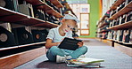 Girl, child and tablet with books in library for education, growth and development with online course. Kid, digital touchscreen and e learning for language, assessment and smile for info at school