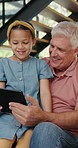 Tablet, search and grandfather with girl child in a house with video, sign up or movie streaming app. Digital, love and senior man with kid in a living room for game, app or cartoon