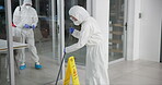 Professional, office and cleaning service and disinfect, mopping and sterilization for health care. Germ, protection and virus with safety suit for chemical exposure, fumigation team and hygiene mask