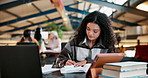 University, laptop and woman writing  with books at campus cafe for research, planning or homework project. College, sticky note or girl student with notebook, planner or reminder with elearning exam