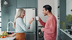 Happy couple, talking and toast with coffee in home kitchen for morning breakfast drink together. Man, woman and cheers with tea for celebration, conversation and interracial people laughing in house