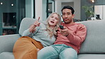 Couple, remote and sofa in home talking, choice and cable show or video on television for relax and bonding. Steaming, movie subscription and discussions on watching tv, media broadcast and comfort