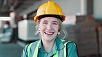 Woman, face and warehouse for engineering and logistics with industry confidence in stock, shipping or production. Portrait of young contractor, worker or person in safety helmet and smile at factory