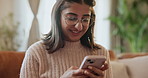 Happy woman, student and typing with phone on sofa for communication, social media or browsing at home. Young female person with smile on mobile smartphone in online chatting, texting or app at house