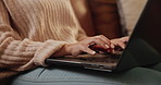 Woman, hands and typing with laptop on sofa for communication, email or research at home. Closeup of female person, journalist or writer on computer for online browsing or remote work in living room