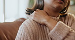 Woman, hand and shoulder injury on sofa with stress in discomfort, pain or anxiety at home. Closeup of female person with sore muscle tension or ache in depression, joint inflammation or fibromyalgia