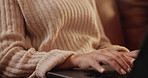 Confused woman, hands and typing with laptop on sofa for communication, email or research at home. Closeup of female person, journalist or writer in doubt on computer for remote work in living room