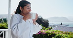 Coffee, happy and Indian woman on balcony in morning with beverage, latte and caffeine for breakfast. Hospitality, hotel and person with drink on holiday, vacation and weekend to relax outdoors