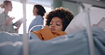 Healthcare, bed and child with sleeping in clinic for pediatric fatigue, sick and recovery. Medical, pediatrician and little boy with dreaming in low angle for rest, treatment and rehabilitation