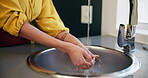 Hand, apple and washing in sink with water for eating with freshness in kitchen for nutrition in health. Organic, wellness and fruit with tasty or delicious with vitamin c for nutritionist in house.