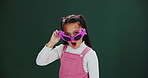 Wow, face and girl with sunglasses in studio for surprise, news or unexpected fashion discount promotion on green background. Omg, portrait and child shocked by trendy frame, deal or announcement