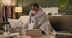 Woman, cold and tissue with blanket on sofa for blowing nose, recovery or winter virus in living room. African person, infection or sick with fever, sinus and allergy on couch in home with healthcare