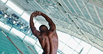Back, stretching and black man swimmer at pool for fitness,  training or water sports in gym. Body, exercise and health with warm up of professional athlete swimming for competition or wellness