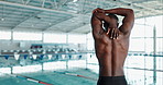 Swimming, back and black man with stretching by pool for cardio training, warm up and flexibility. Athlete, practice and person with preparation at sports arena for fitness, exercise or muscle health