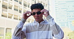 Teen, boy and outdoor in confidence for fashion campaign with outfit, clothes and street style in Spain. Portrait, gen z and sunglasses with swag, cool and trendy wear for urban culture and cool