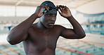 Black man, prepare and swimmer with goggles, swimming cap or athlete for morning workout. Sports, wellness and male person by pool for performance training, water competition or confidence in race