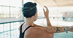 Back, stretching and woman with warm up by swimming pool for cardio exercise, start and preparation. Athlete, training and person with flexibility at sports arena for fitness, practice and workout