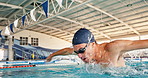 Water, swim and butterfly for male athlete in pool, swimmer and stroke for practice. Professional, splash or goggles for exercise and cardio, training and routine for competition preparation or race 