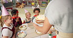 Children, teacher and birthday cake in classroom for school party with friends for celebration, dessert or group. Boys, girls and hats with happiness event at education academy, students or together