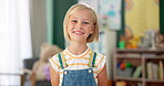 Girl, child and face or happy in classroom for education, knowledge or fun learning with confidence. Student, person and portrait with smile at kindergarten for studying, pride and academy or school