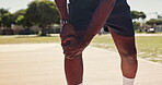 Legs, knee pain and athlete with injury outdoor at basketball court for exercise, fitness or training accident. Hands, sports person and massage muscle for fibromyalgia, arthritis or health problem