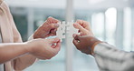 People, hands and puzzle for teamwork, collaboration and working together for business goal or challenge. Corporate group, team and jigsaw piece for synergy, cooperation and problem solving at office