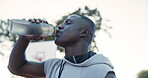 Exercise, sports and black man drinking water on basketball court for break or hydration in summer. Fitness, health and wellness with athlete outdoor for competition, game or performance training