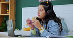 Student, laptop and girl with fidget toy for adhd, stress and writing notes on book in home bedroom. Music, headphones and woman in bed for learning, education and study for exam with sensory tangle