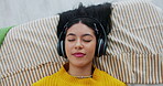 Face, music and girl in bed for relaxing, resting and comfortable while sleeping in home. Above, radio and podcast with headphones by person in bedroom, daydreaming and chilling with playlist 