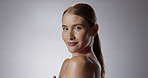 Woman, portrait and smile on gray background for beauty with makeup in confidence for self esteem. Aesthetic, pride and skincare in studio for wellness with face or routine in Germany with happy.