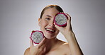 Dragon fruit, woman and portrait with smile in studio for health or face in confidence for self esteem. Vitamin C, immune system and magnesium for low iron with wellness isolated on gray background.