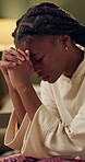 Trust, christian or praying girl at home for faith, hope or gratitude with prayer. Religious, black woman or hands together to seek guidance, wisdom or blessings for personal growth from God in house