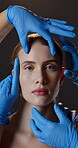 Face, hands in gloves and plastic surgery with woman in studio on dark background for change. Aesthetic, portrait and transformation with serious person at clinic for beauty, consulting or cosmetics