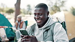 Camping, phone and black man by tent with friends for holiday, vacation and adventure outdoors. Travel, campsite and person on smartphone for social media to relax in countryside, nature and forest