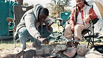 Friends, cooking and camping fire in nature, smile group and holiday or vacation with food. Bonfire, adventure and bonding together with meal in outdoor, campsite for warm or picnic in park
