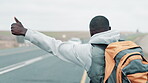 Black man, hike and thumbs up on highway for road trip journey or adventure, tour with hitchhiking to see countryside. Person, hand gesture for car stop for transportation and commute on vacation.